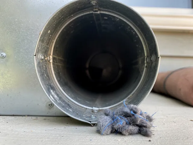 Hinesville Dryer Vent Cleaning technician using specialized equipment to clear severe dryer vent blockage in Hinesville